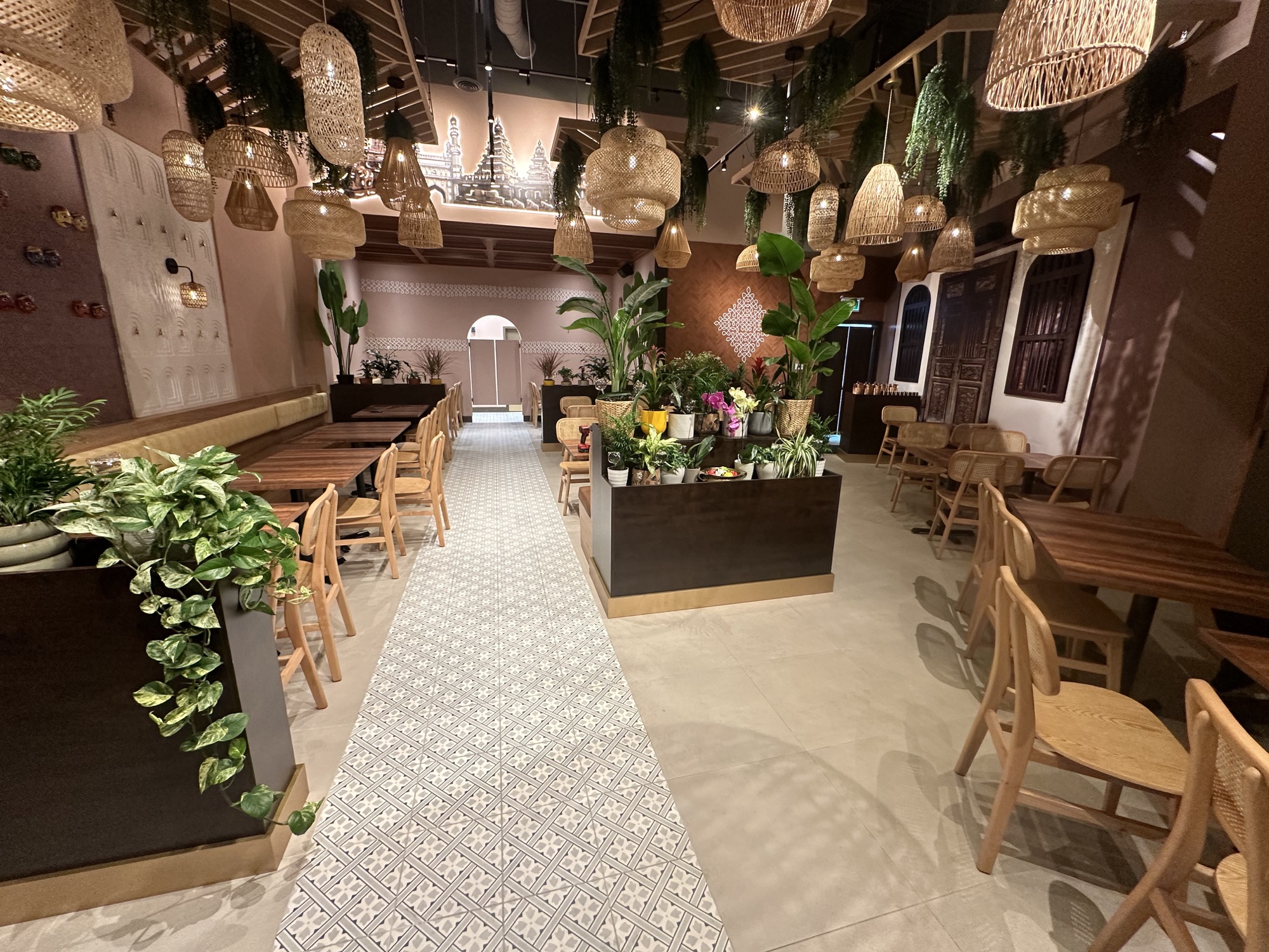 Bright contemporary café with green booth seating and light wood tables
