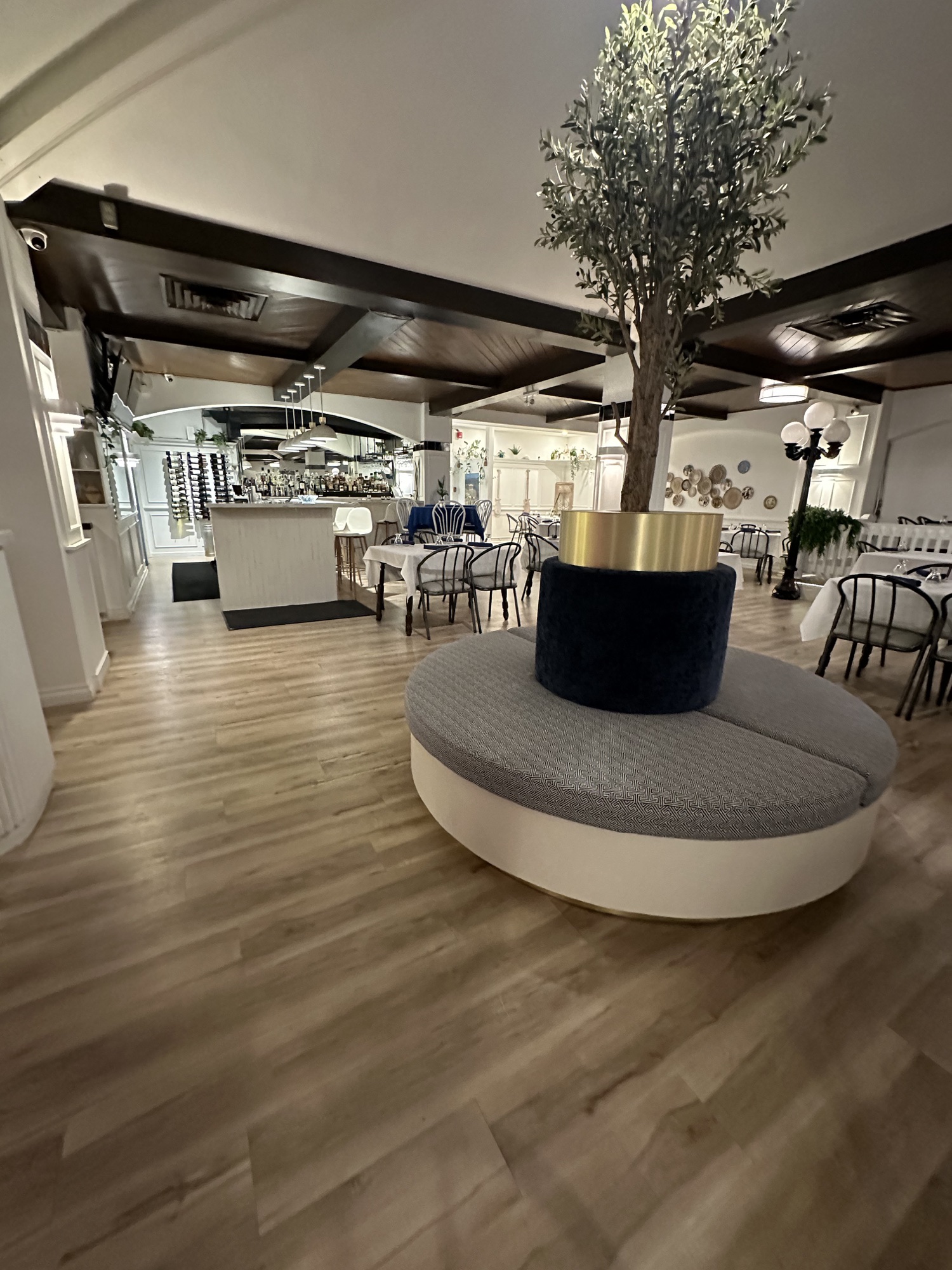 Custom curved booth seating arranged around round dining tables